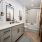 bathroom with a large mirror and ample lighting